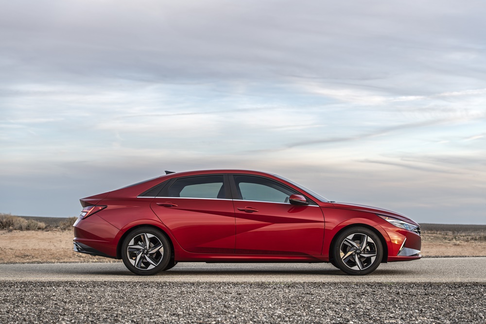 Novo Hyundai Elantra vermelho visto de perfil tem vincos que formam uma cavidade em forma de seta na porta dianteira